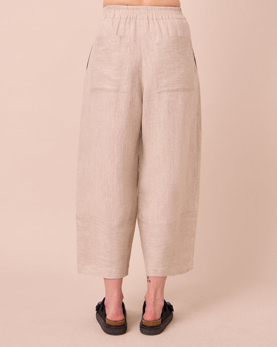 model wears bobbi natural linen trousers back