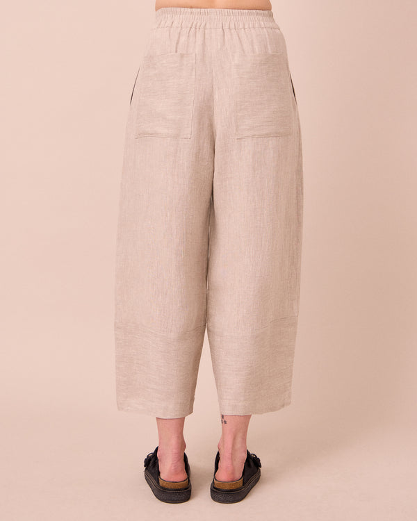 model wears bobbi natural linen trousers back