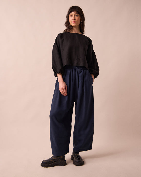 model wears bobbi navy linen trousrs left
