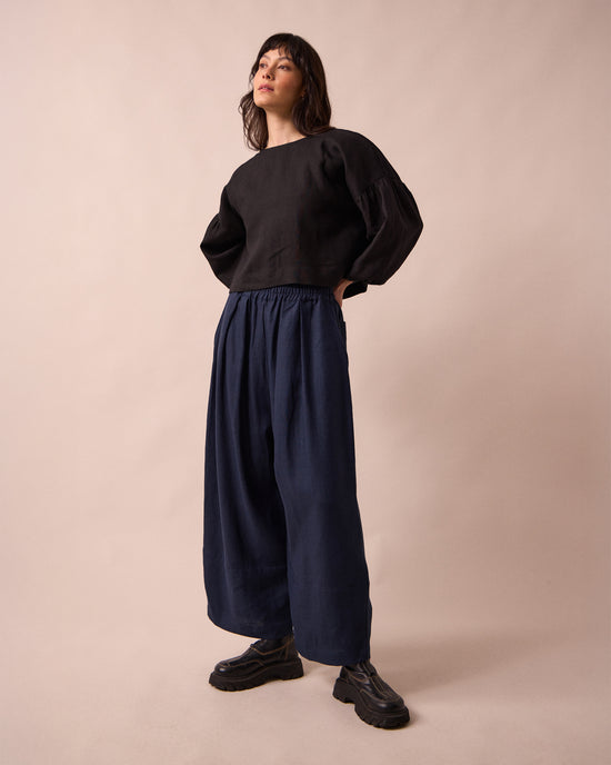 model wears bobbi navy linen trousrs right