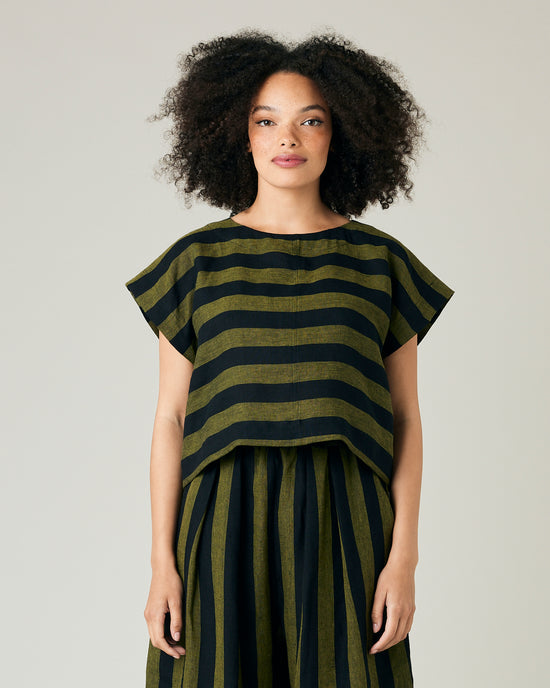 model wears olive and black stripe linen polly top