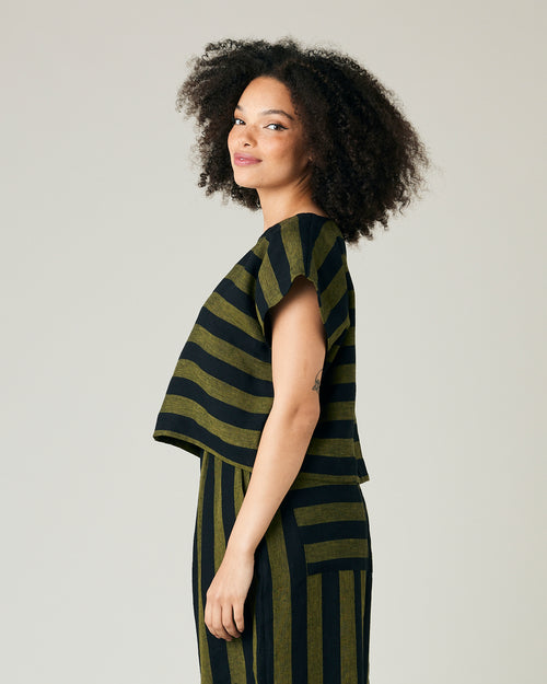 model wears olive and black stripe linen polly top