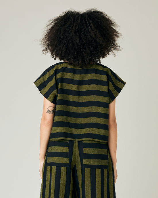 model wears olive and black stripe linen polly top