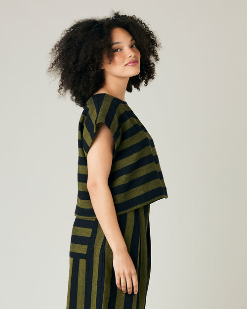 model wears olive and black stripe linen polly top