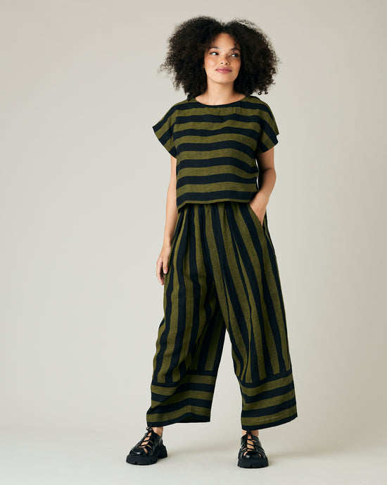 model wears olive and black stripe linen polly top