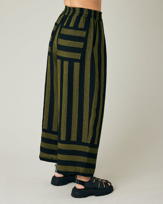 model wears black and olive stripe bobbi trousers right