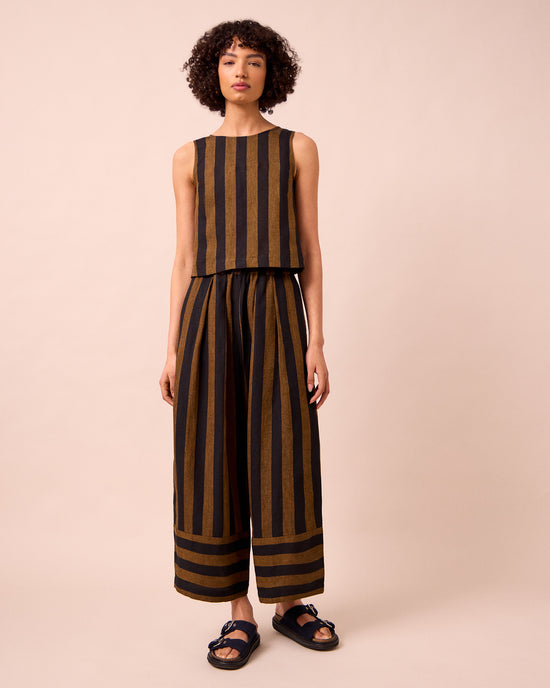 model wears bobbi rust stripe linen trousers right