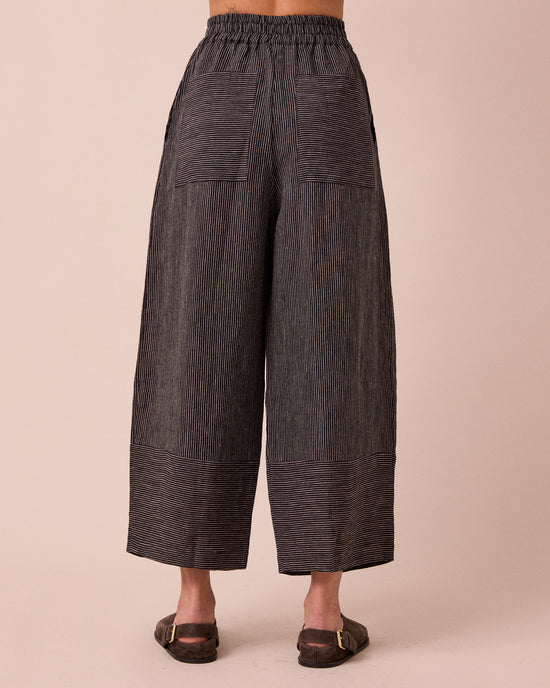 model wears bobbi black and ecru pencil stripe linen trousers back
