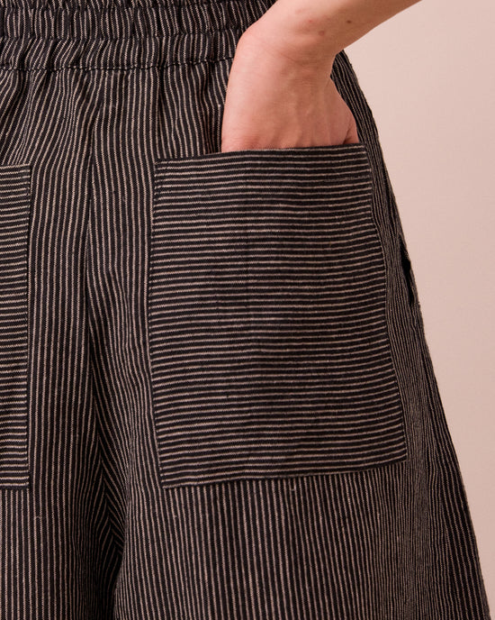 model wears bobbi black and ecru pencil stripe linen trousers 