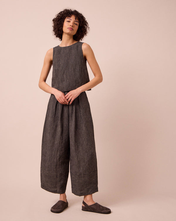 model wears bobbi black and ecru pencil stripe linen trousers right