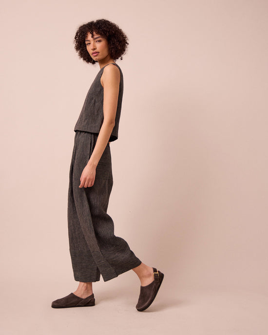 model wears bobbi black and ecru pencil stripe linen trousers left