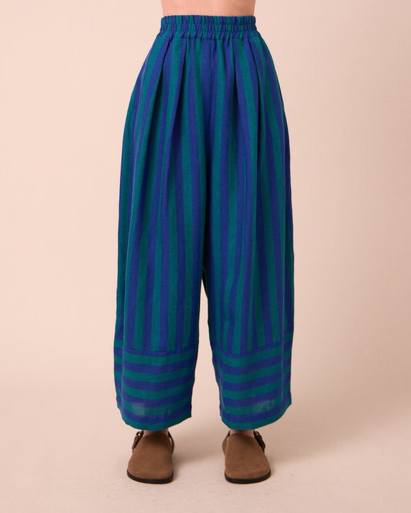 model wears bobbi house blue linen trousers front