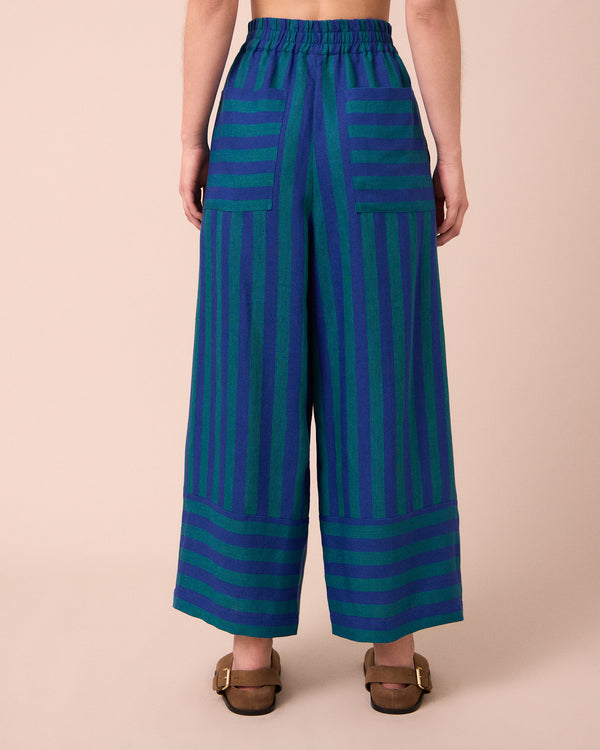 model wears bobbi house blue linen trousers back