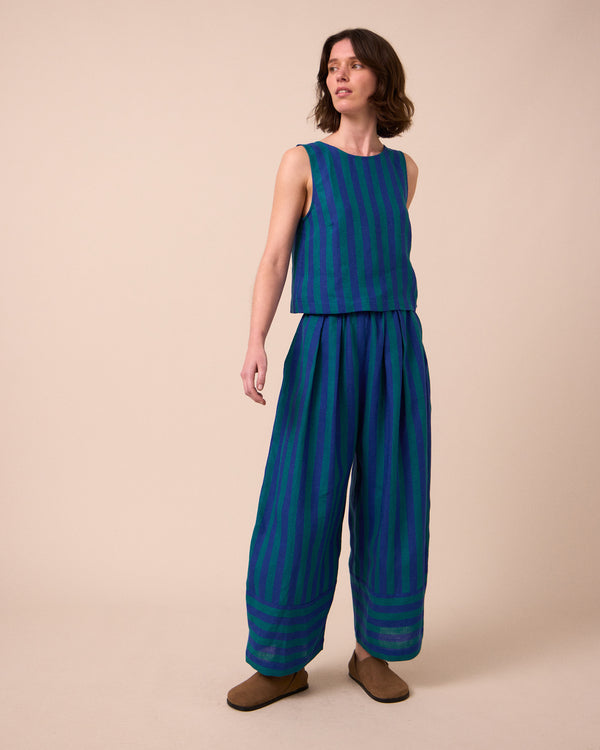 model wears bobbi house blue linen trousers right