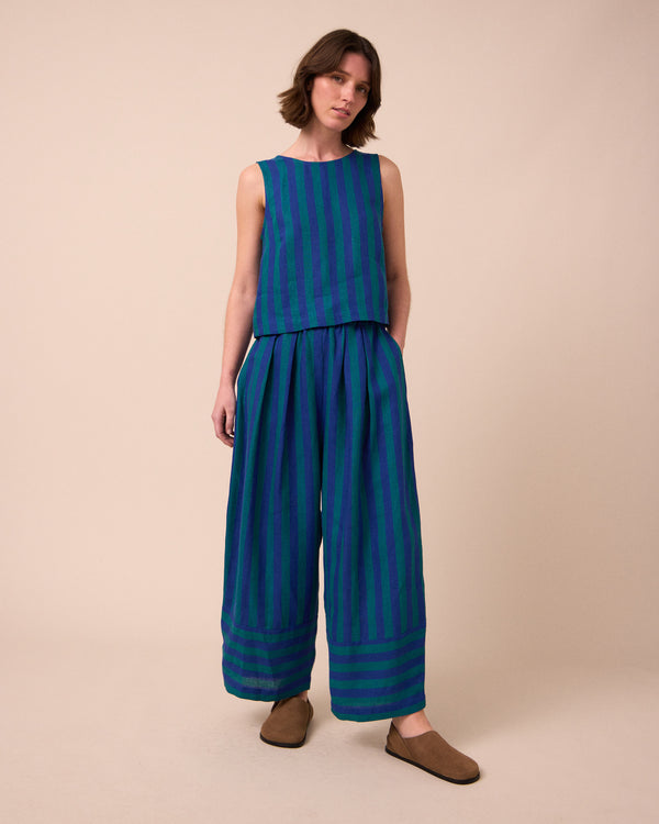 model wears bobbi house blue linen trousers left