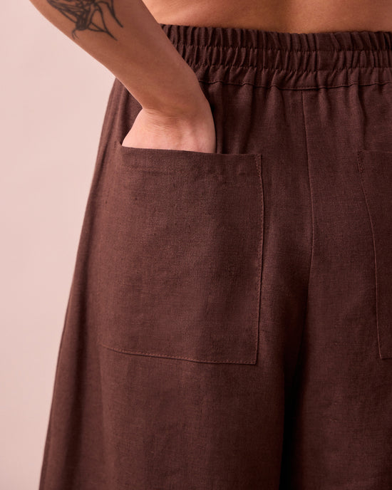 model wears bobbi chocolate linen trousers