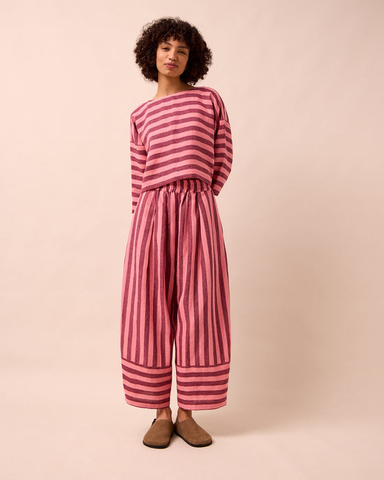 model wears bobbi fiesta pink linen trousers left