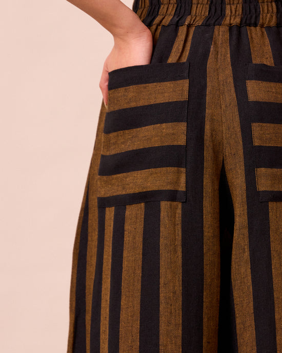model wears bobbi rust stripe linen trousers