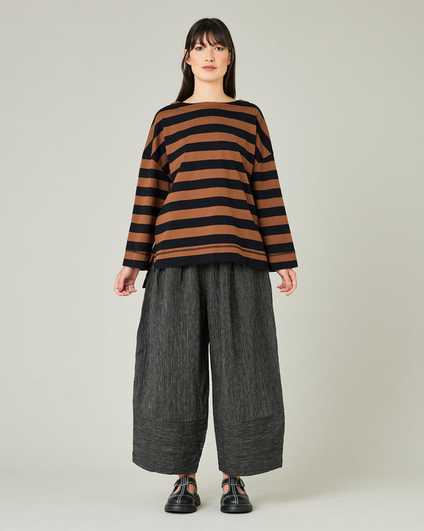 model wears black and ecru pencil stripe bobbi trousers