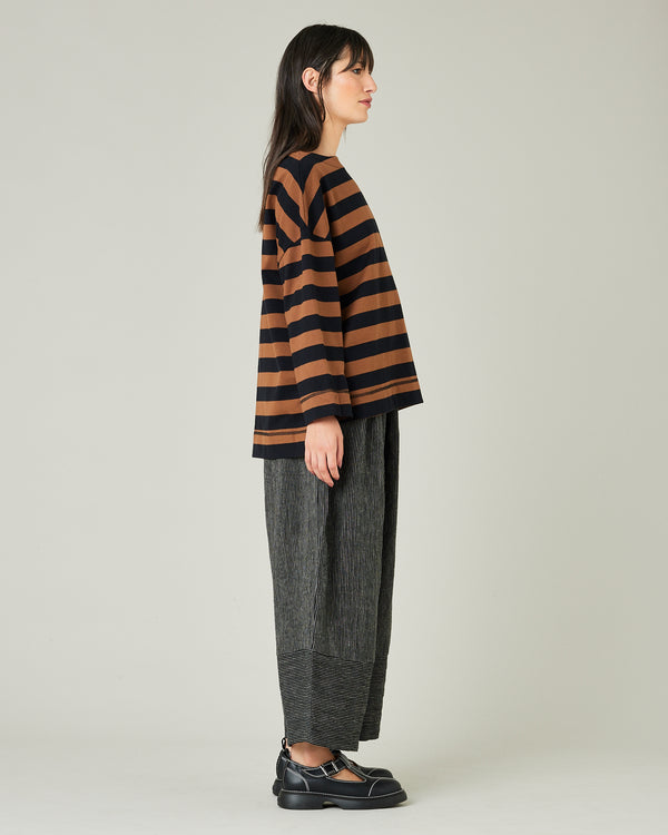 model wears black and ecru pencil stripe bobbi trousers