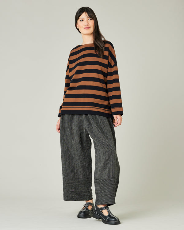 model wears black and ecru pencil stripe bobbi trousers