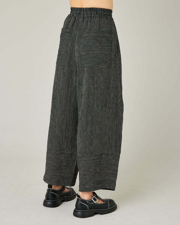 model wears black and ecru pencil stripe bobbi trousers right