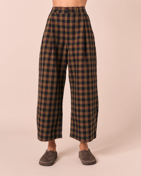 model wears chestnut check denim jeans front