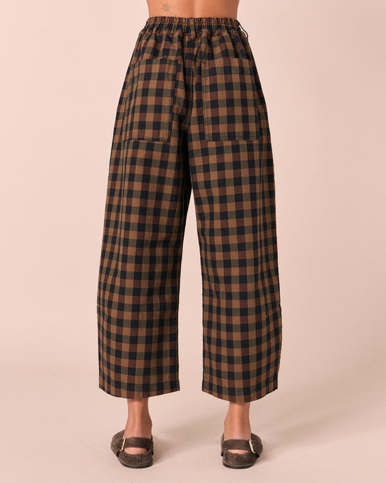 model wears chestnut check denim jeans back