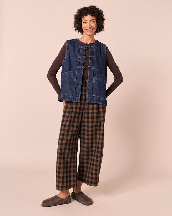model wears chestnut check denim jeans left