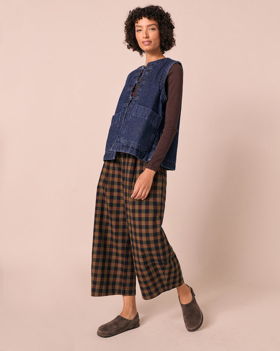 model wears chestnut check denim jeans right