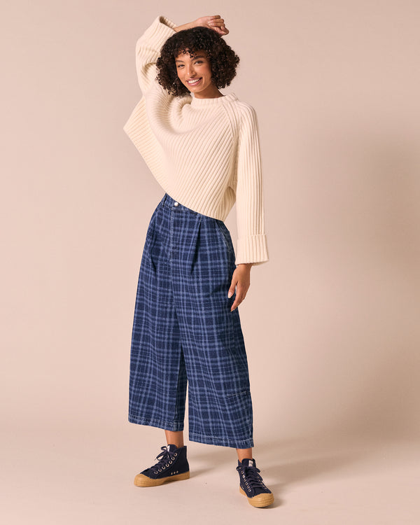 model wears bonnie mid wash plaid jeans left