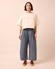 model wears bonnie navy pinstripe denim jeans left