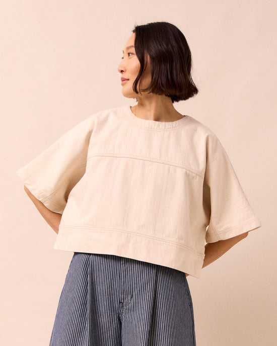 model wears eva ecru denim top