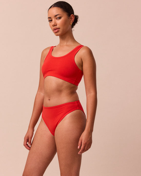 model wears tomato red jersey bralette