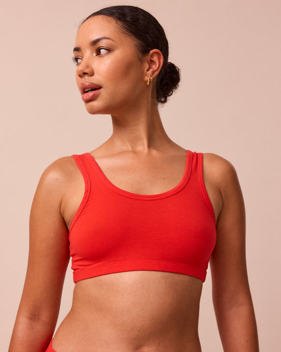 model wears tomato red jersey bralette