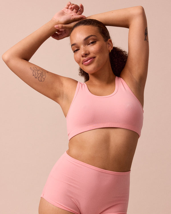 model wears petal pink jersey bralette