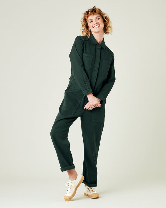 model wears bottle green coverall