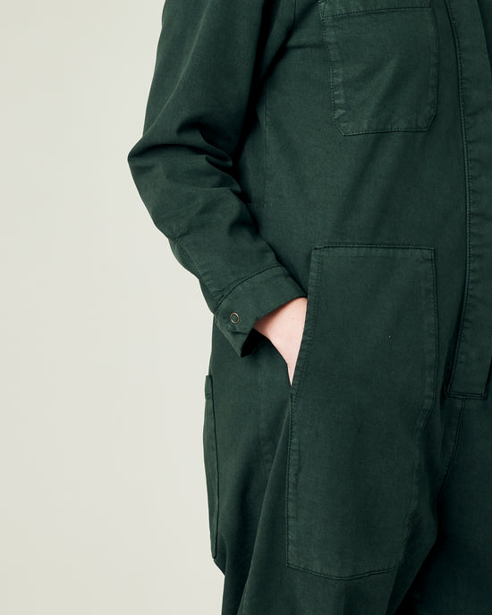 model wears bottle green coverall