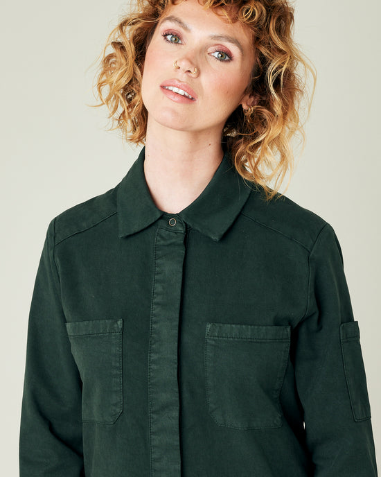 model wears bottle green coverall