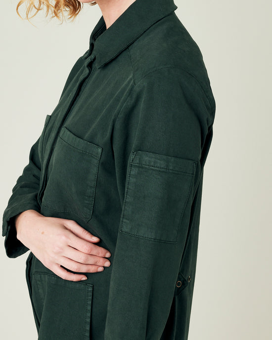 model wears bottle green coverall