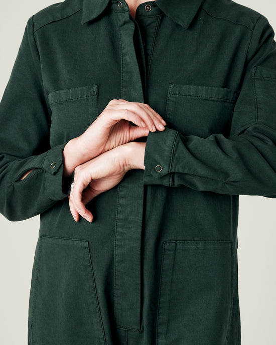 pregnant model wears bottle green coverall