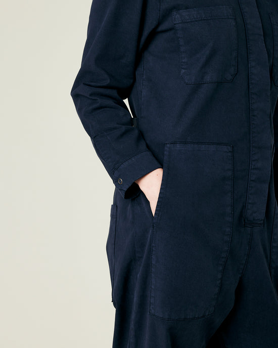 model wears navy coverall 