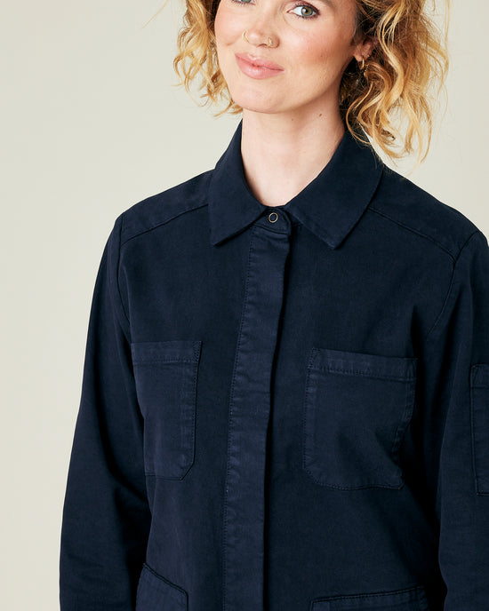 model wears navy coverall 