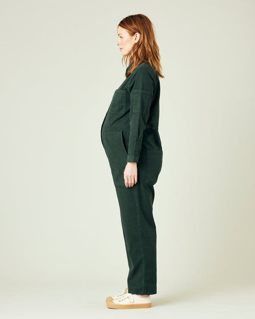 pregnant model wears bottle green coverall