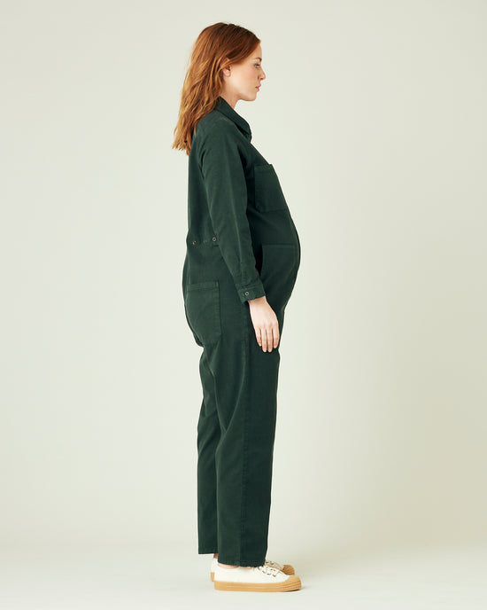 pregnant model wears bottle green coverall