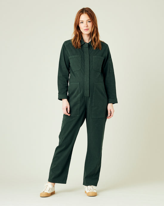 pregnant model wears bottle green coverall