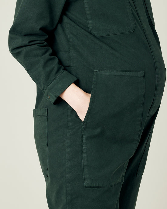 pregnant model wears bottle green coverall