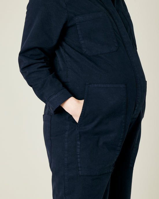 pregnant model wears navy coverall 