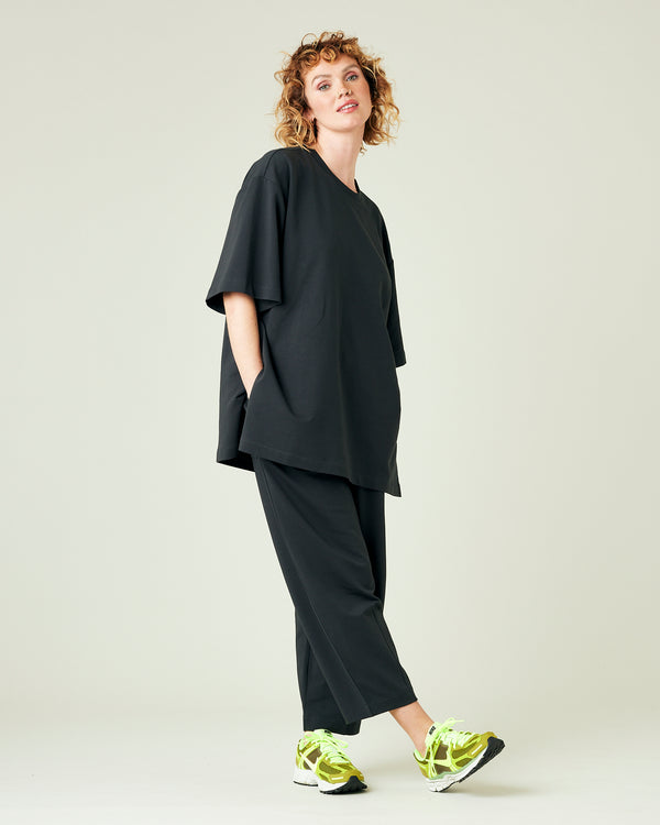 model wears slate jersey huxley trousers