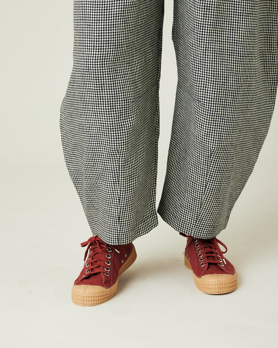 model wears black and black micro gingham daisy trousers